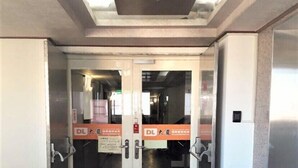 A double door entrance with glass panels and a sign above. - Hsinchu World Trade Business Hall (Hsinchu)