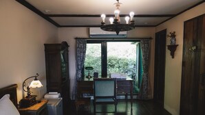 A bedroom with a bed, a desk, a chair, a lamp, and a window with curtains. - Deep Breath B&B (Shoufeng)