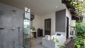 A modern bathroom with a glass shower enclosure, a marble sink, and a built-in bathtub. - 3 Bedroom Balinese Style Villa, Lovely Villa Close to Shopping Area Seminyak (Seminyak)