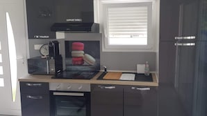 A compact kitchen with a built-in oven, a microwave, and a small refrigerator. - Apartment with pool and magnificent views in the South of France (Saint-Chamas)
