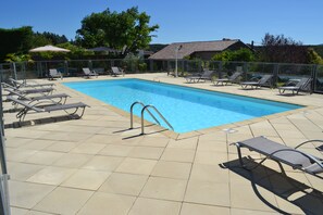 Seasonal outdoor pool, open 9:00 AM to 7:00 PM, pool umbrellas