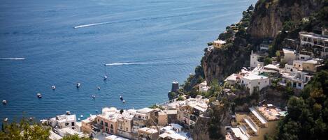 A coastal town with buildings on a cliff overlooking the sea.