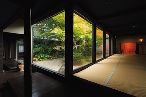 A room with tatami flooring, large windows, and a view of a garden. - Oyado Hana Kanzashi (Nihommatsu)