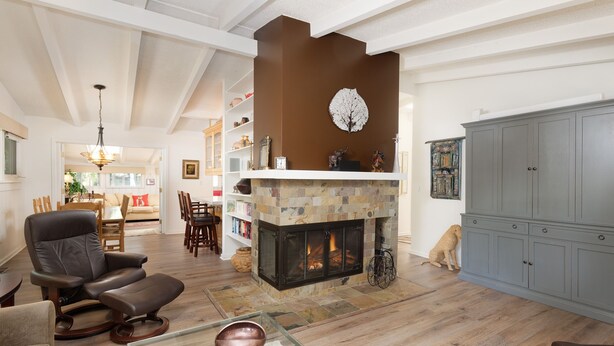 A living room with a fireplace, leather recliner, and a glass coffee table. - Aspen West End  - Quiet Neighborhood 3 Bedroom Home by RedAwning (Aspen)