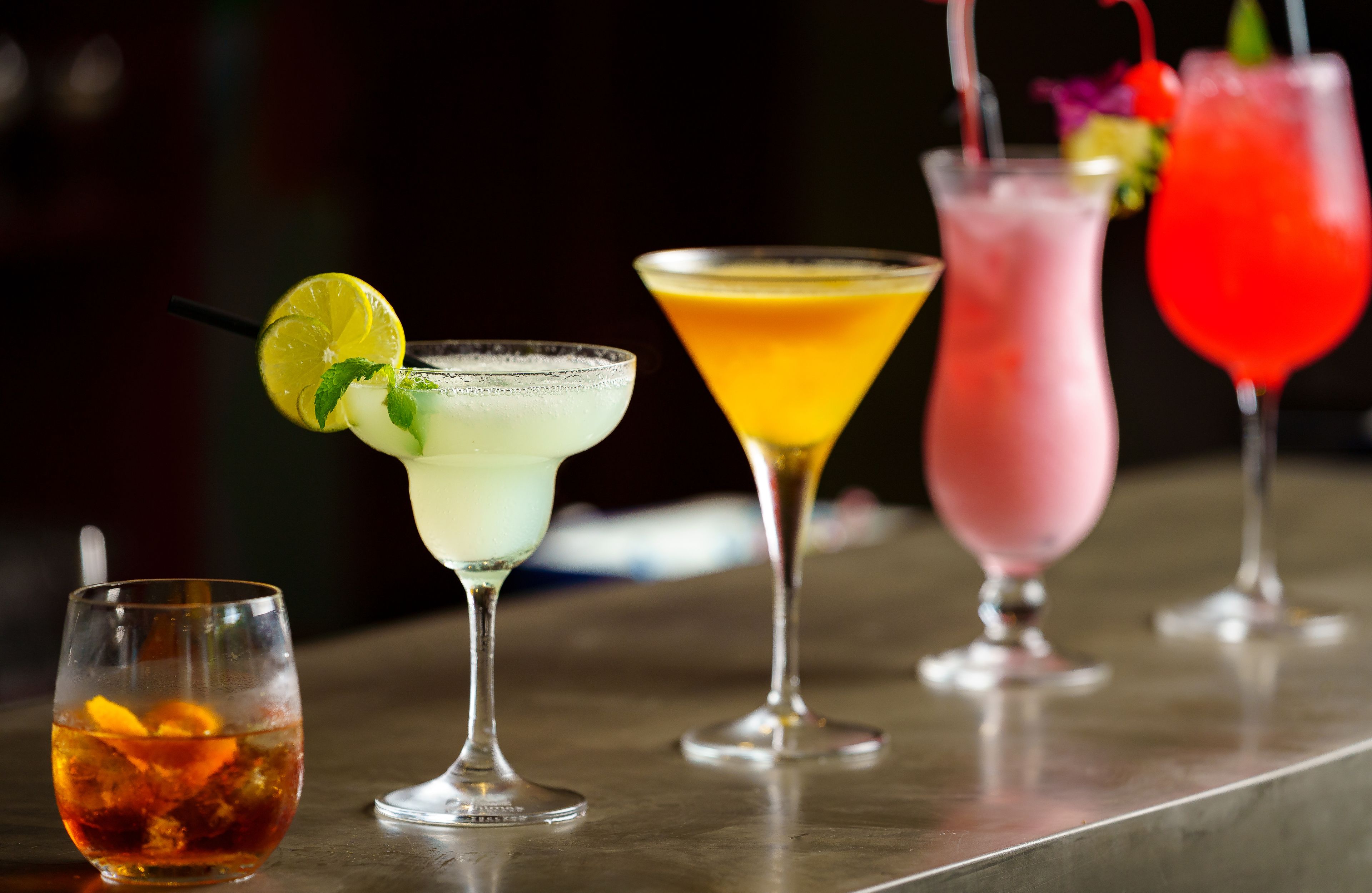 A variety of cocktails on a bar counter.