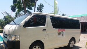 A white van parked near a pool with a sign indicating Villa Catalina Resort. - Villa Catalina Bora Resort (Nabas)