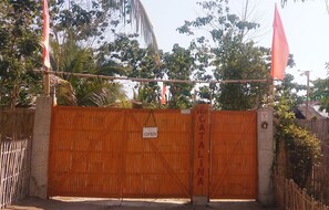 A gated entrance with a sign reading "OPEN" and "CANTINA." - Villa Catalina Bora Resort (Nabas)