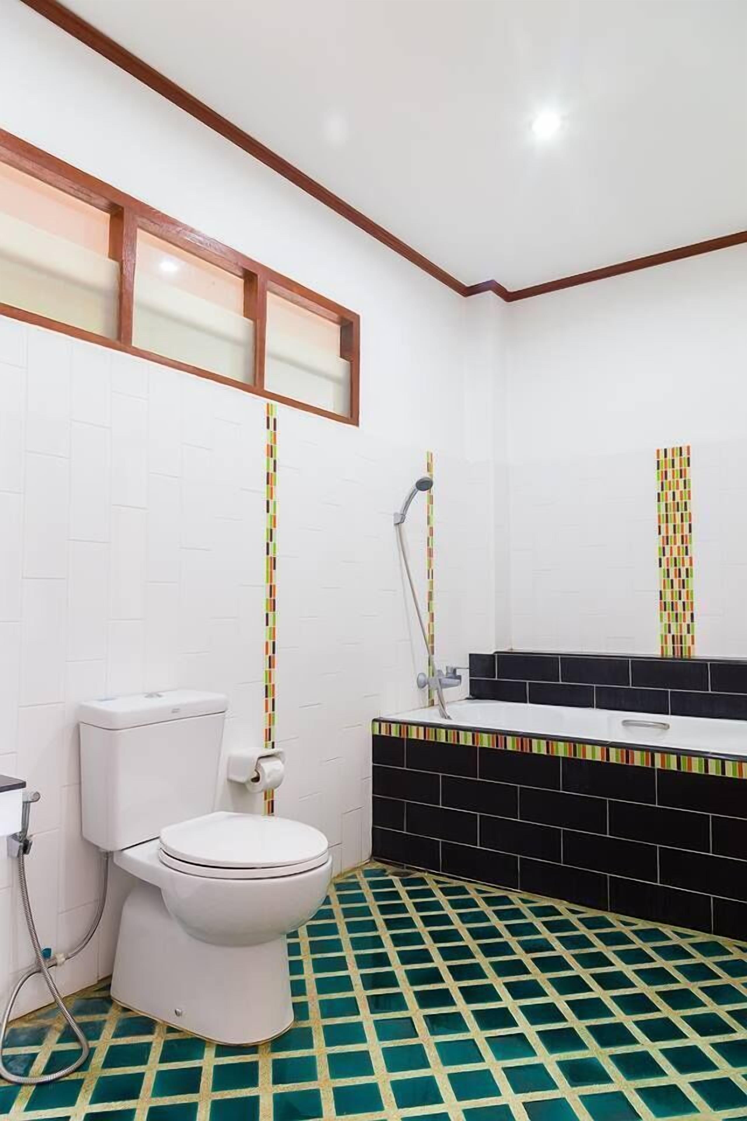 Un baño con inodoro, ducha y lavamanos.