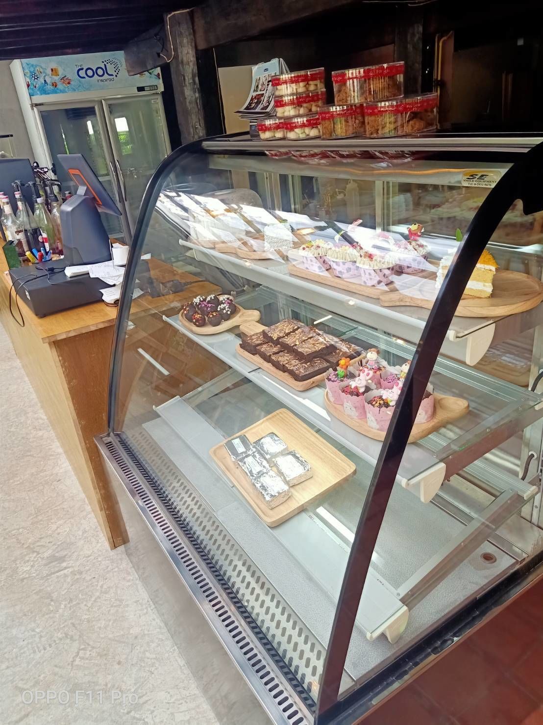 A bakery display case with various pastries and desserts.