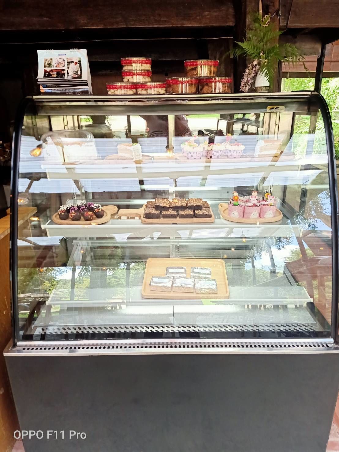 A bakery display case with various baked goods and desserts.