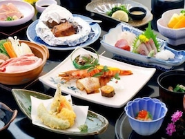 A variety of dishes on a table, including seafood and vegetables.