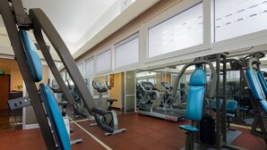 A gym with exercise equipment, a treadmill, and a weight machine. - Sunshine Hotel Nha Trang (Nha Trang)