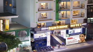 A multi-story hotel with balconies and a sign reading "Sunshine Hotel." - Sunshine Hotel Nha Trang (Nha Trang)