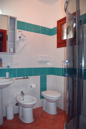 A bathroom with a glass shower enclosure, a bidet, a toilet, and a sink. - RELAX, SUN & SEA ... everything away from home !!! (Olbia)