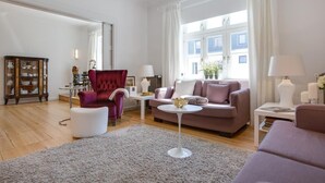 A living room with a sofa, armchair, and a small round table. - The locksmith's shop awarded 5 stars according to DTV (Westerland)