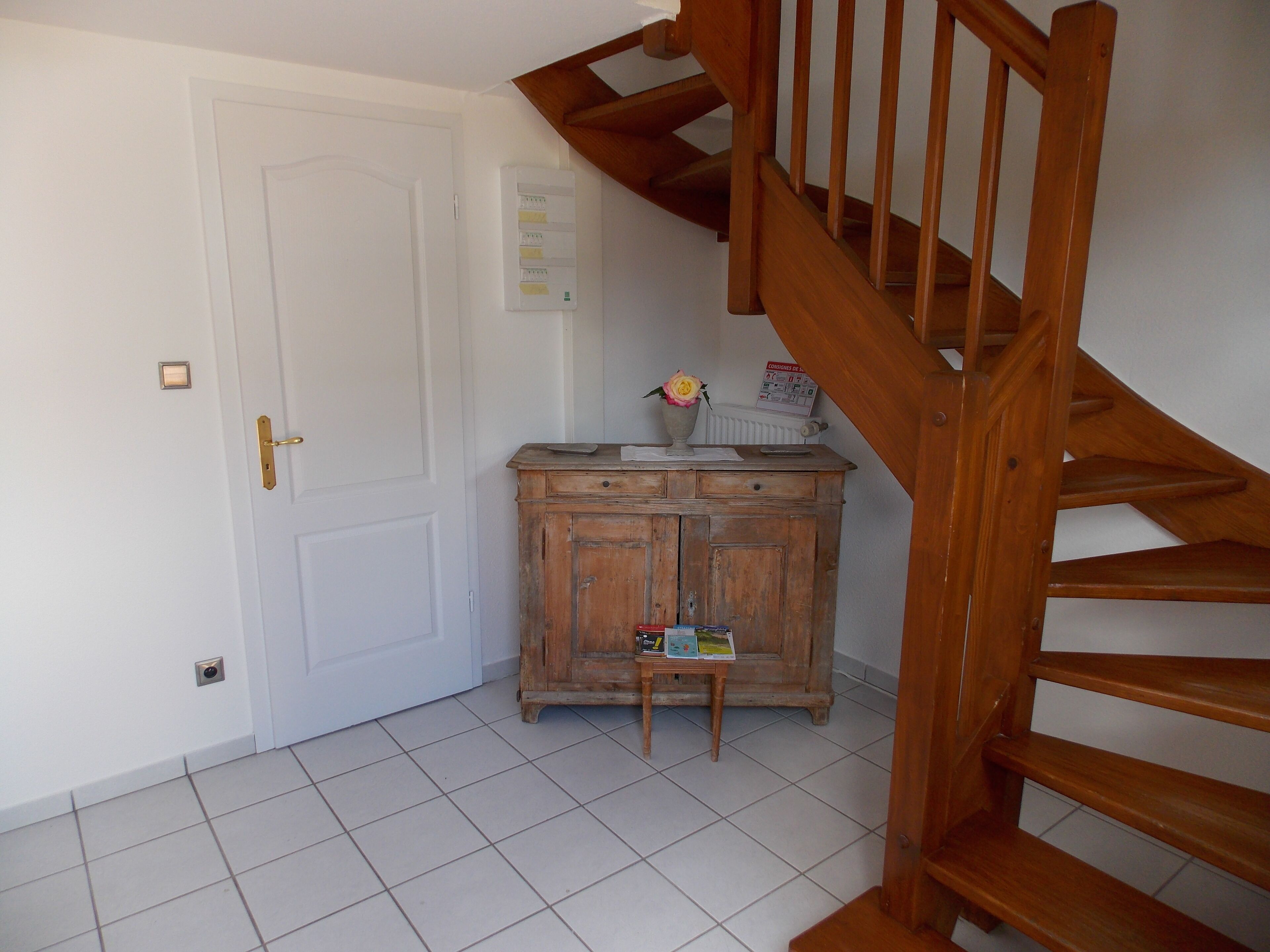 A staircase with wooden steps and a handrail, leading to an upper floor.
