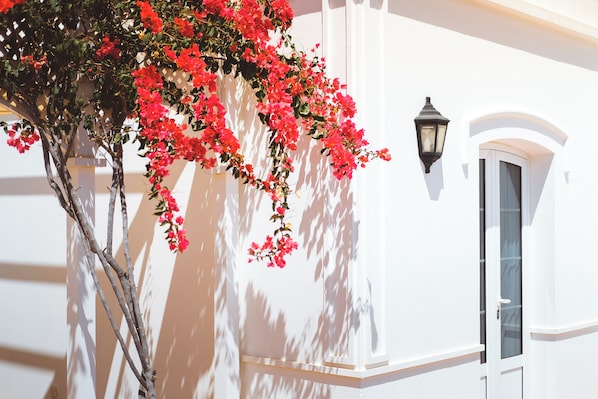 Un bâtiment blanc avec une fenêtre et un luminaire fixé au mur.
