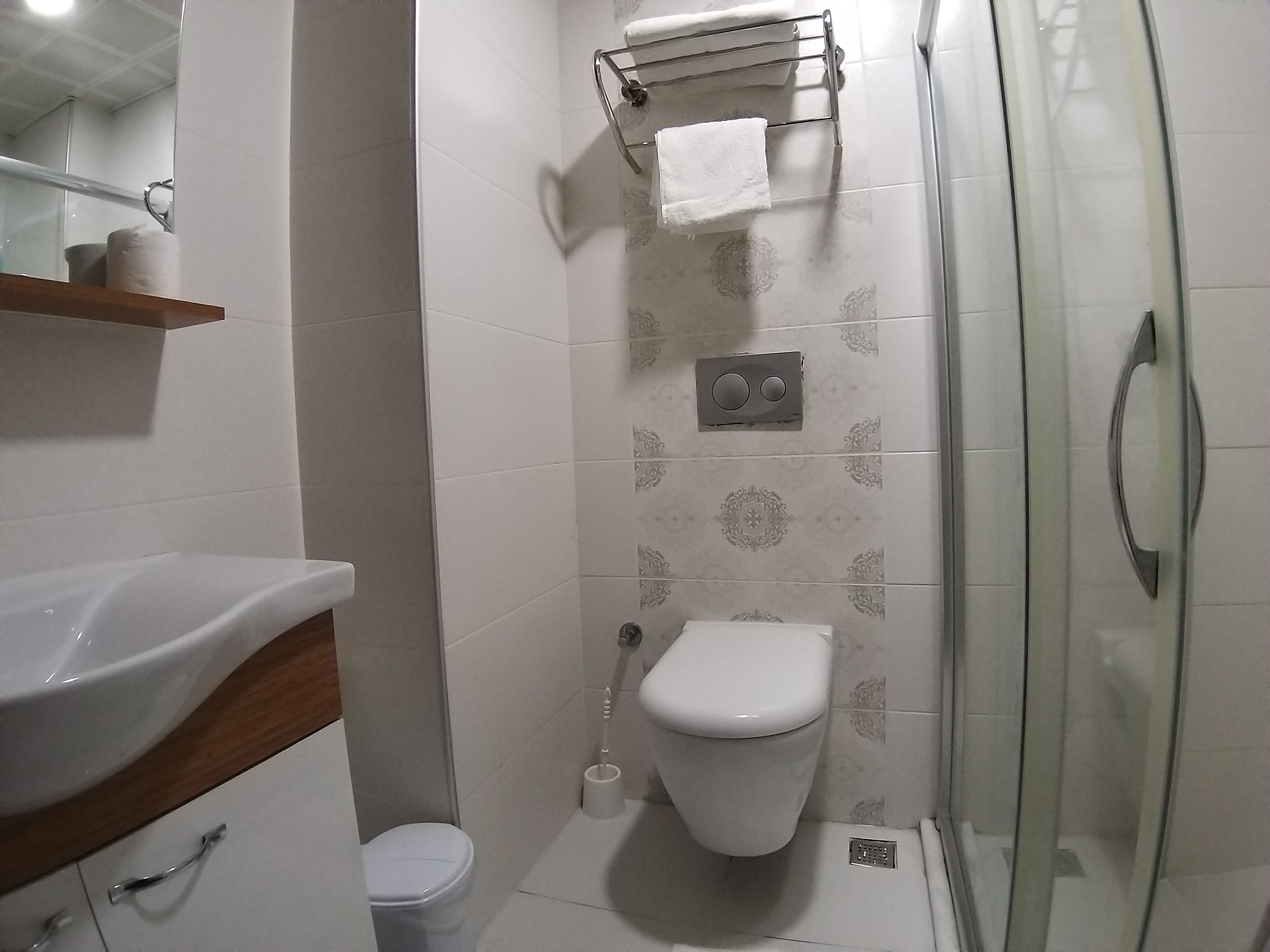 shower, hair dryer, slippers, towels