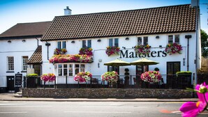 A white building with a tiled roof and a sign reading "Maltsters." - The Maltsters Arms (Cardiff)