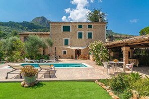 A stone building with a swimming pool, outdoor seating, and a garden. - VILLA FRONTERA - Villa with private pool and views to the mountains in Soller Free WiFi (S��ller)