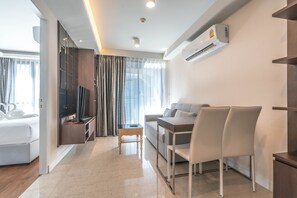 1-Bedroom Apartment | Living area | Flat-screen TV