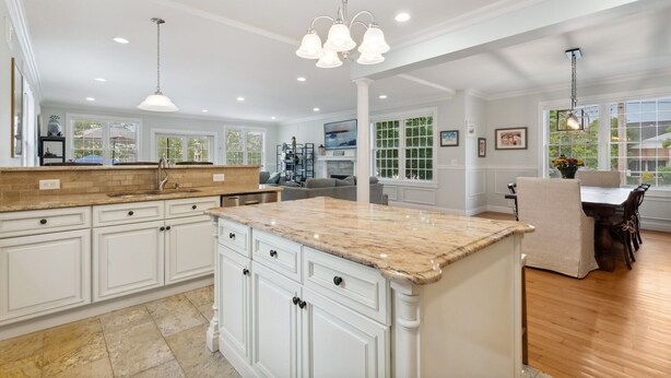 A spacious kitchen with white cabinetry, a marble island, and pendant lighting. - Luxury Home a Short Walk to Beach and Town with Amazing Reviews  (Point Pleasant Beach)