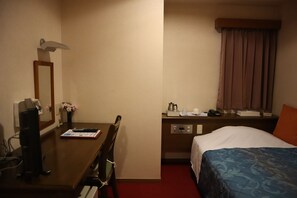 A hotel room with a bed, a desk with a chair, a telephone, a coffee maker, and a window with curtains. - Akabane Plaza Hotel (Tokyo)