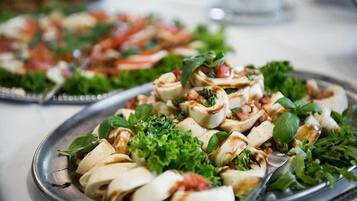 A plate of food with sliced vegetables and herbs.