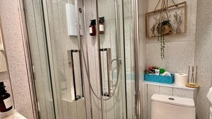 A modern bathroom with a glass-enclosed shower, a toilet, and a sink. - @part Bernard Rooms (Edinburgh)