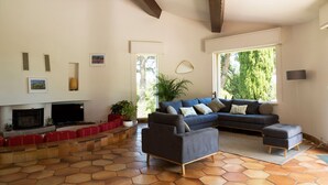 A living room with a fireplace, a sectional sofa, and a TV. - Architect's Villa In The Heart Of The Vines Near Avignon (Châteauneuf-de-Gadagne)