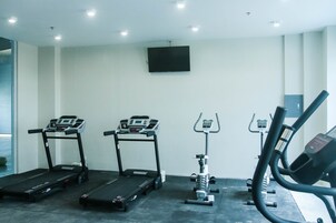 A gym with treadmills, an elliptical, and a stationary bike.