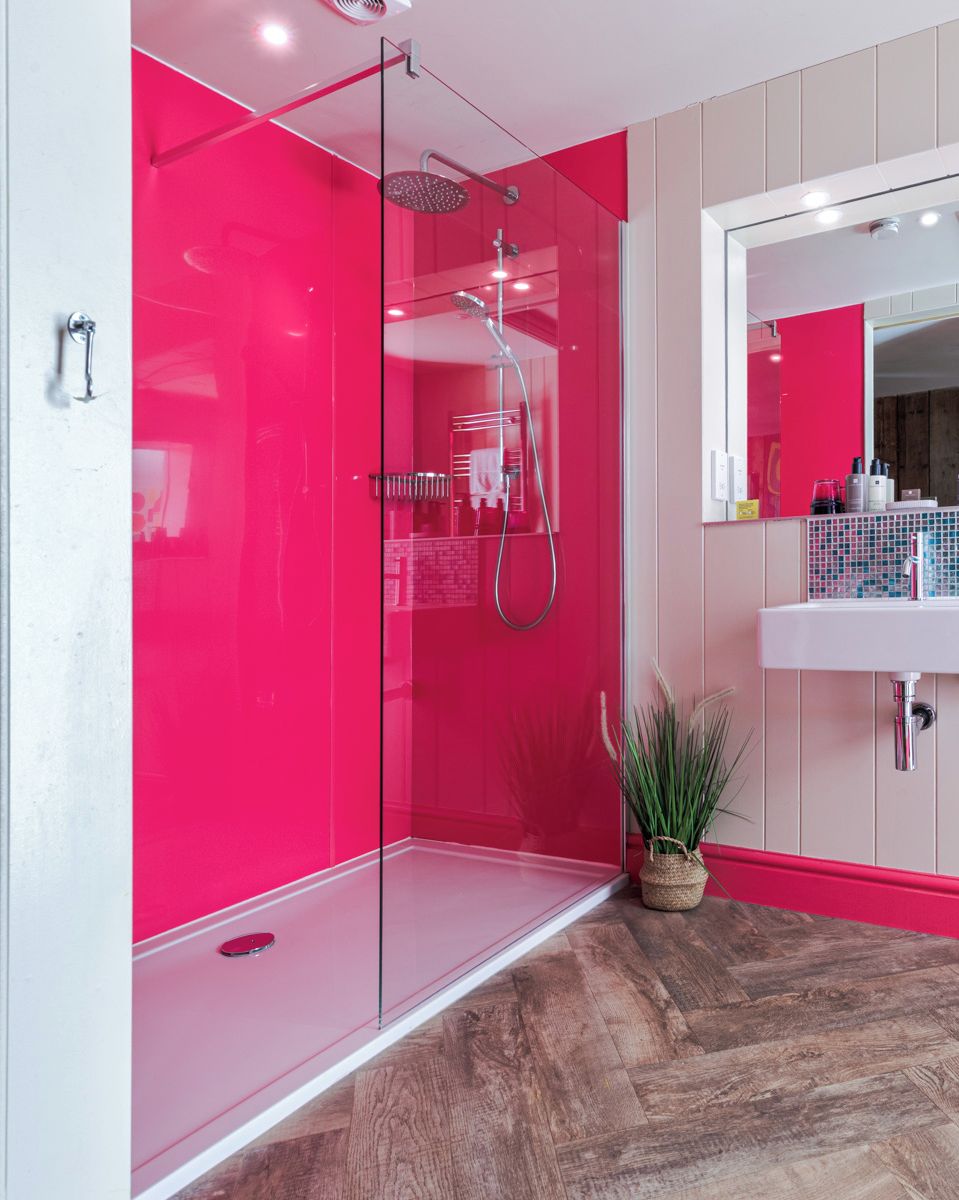 A modern bathroom with a glass-enclosed shower, a white sink, and a mirror above it.