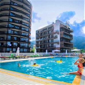 2 outdoor pools, open 8:00 AM to 9:00 AM, pool umbrellas, pool loungers