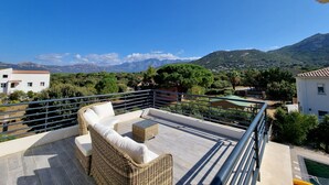 A rooftop terrace with wicker furniture, a pool, and a scenic mountain view. - Architect-designed villa, secure private pool, near center and beach  (Calvi)