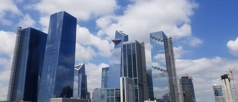 A cityscape with modern skyscrapers and a clear blue sky.