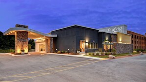 A Fairfield by Marriott hotel with a modern design, featuring a brick facade, a covered entrance, and a well-lit exterior.