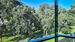 A view from a window overlooking a park with trees and a road. - 44 Vip Hotel (Lima)