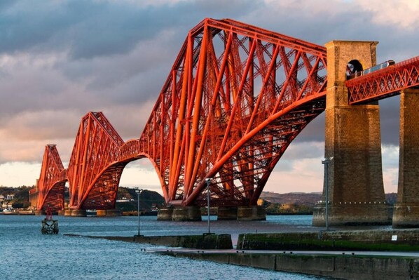 A red steel bridge with multiple arches over a body of water. - No 10 - by StayDunfermline (Dunfermline)