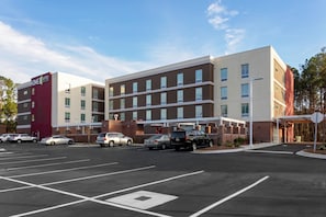 A multi-story hotel with a parking lot in front. - Home2 Suites by Hilton North Charleston-University Blvd (North Charleston)