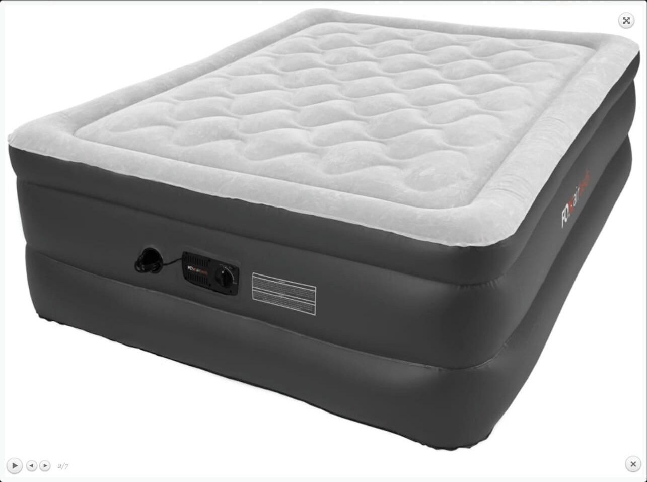 A black portable mattress with a quilted top and a power outlet on the side.