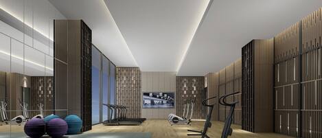 A modern gym with exercise equipment, a large TV screen, and a wooden floor.
