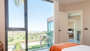 A hotel room with a large sliding glass door leading to a private outdoor area with a pool and garden. - Los Lagos 5- Holiday Rental Salobre Golf (San Bartolomé de Tirajana)