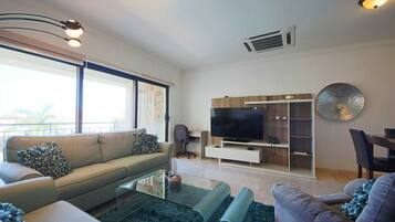 Premium Apartment | Living area | 32-inch Smart TV with cable channels, TV, Netflix