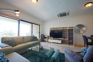 Premium Apartment | Living area | 32-inch Smart TV with cable channels, TV, Netflix