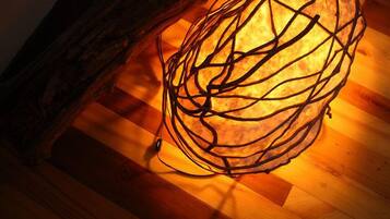 A spherical light fixture with a complex wire design on a wooden floor.