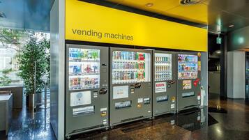 A row of vending machines with a yellow sign above them.