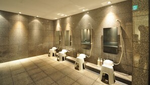 A modern bathroom with multiple sinks, mirrors, and a shower area. - The Grand Palace (Tokushima)