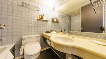 A modern bathroom with a toilet, sink, and mirror. There are shelves with toiletries and a towel rack.