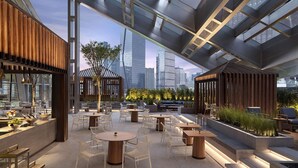 An indoor-outdoor dining area with modern furniture, a city skyline view, and a mix of wooden and metal structures. - Park Hyatt Shenzhen (Shenzhen)
