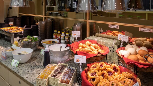 A buffet with various food items and condiments. - Super Hotel Asakusa (Tokyo)